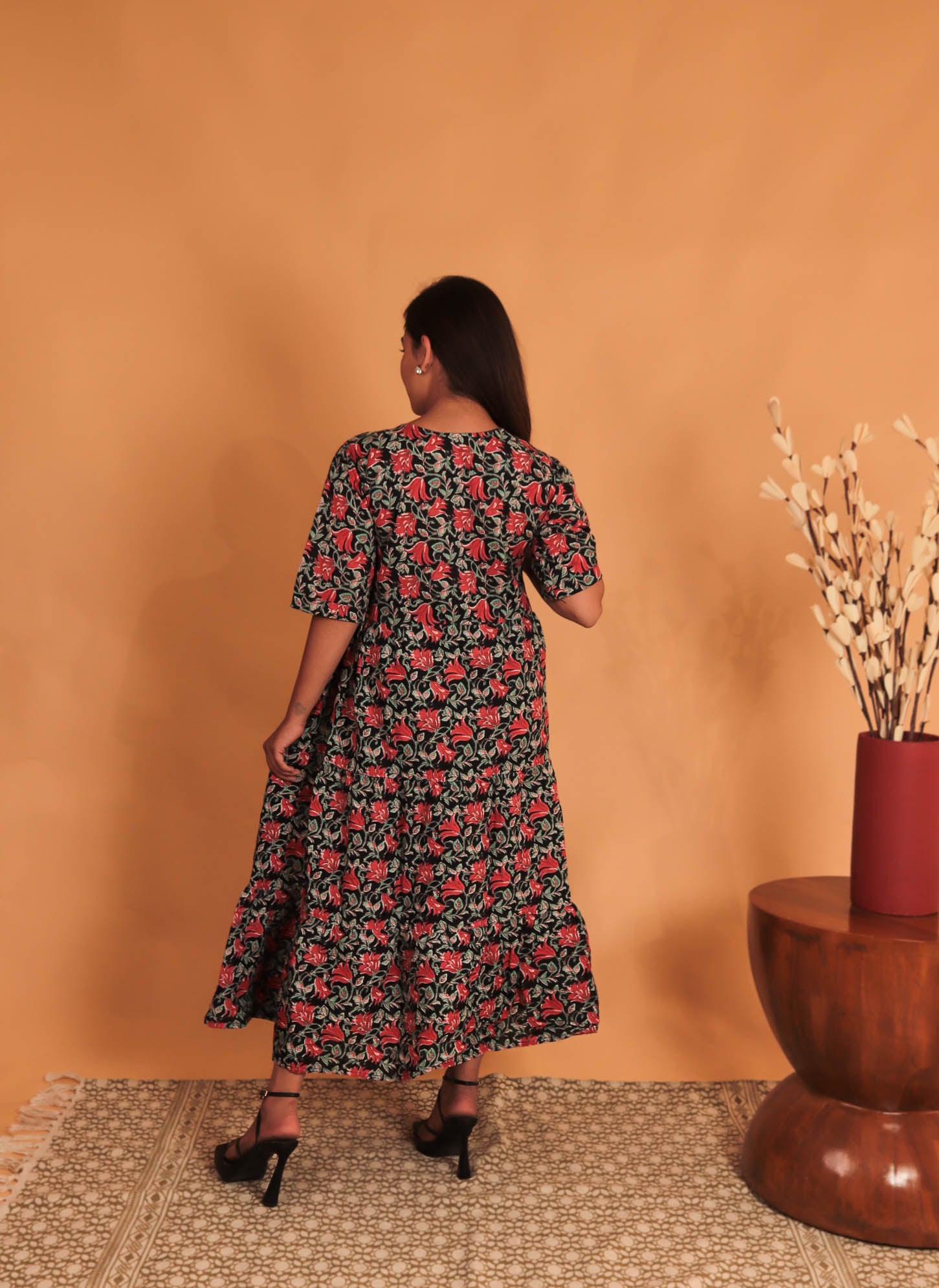 girl in red and grey floral dress