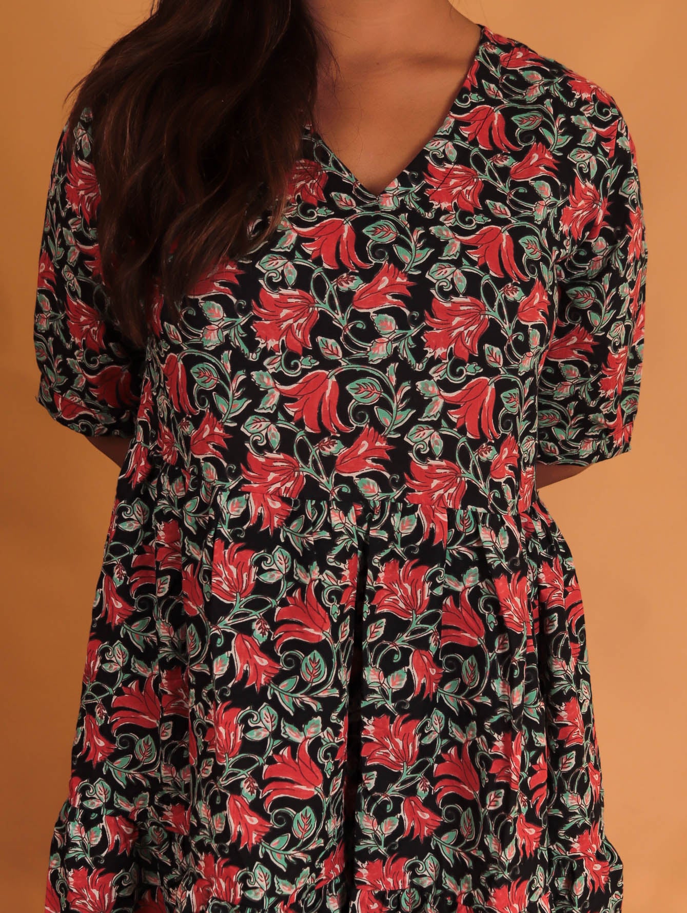 girl in red and black floral dress