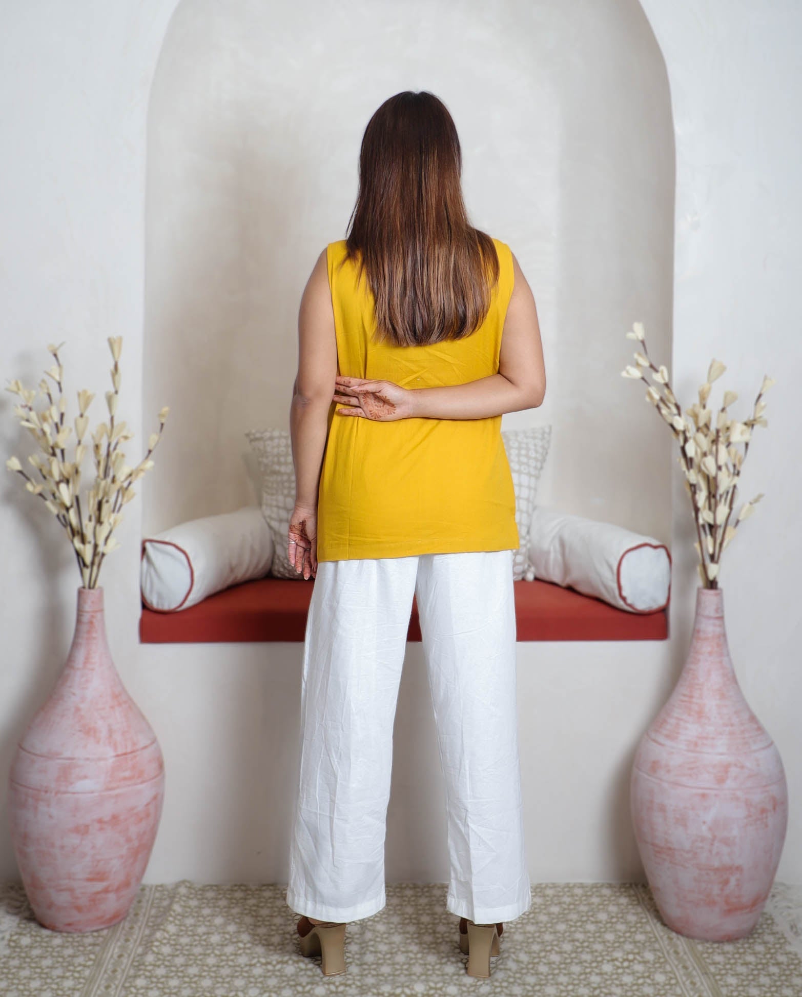 girl in yellow top and white pants