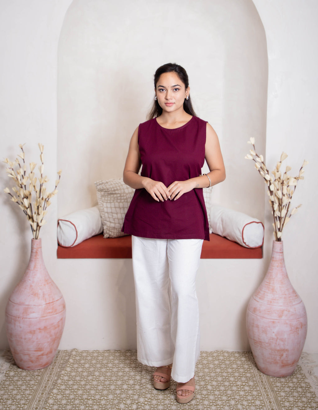 girl wearing maroon top and white pants