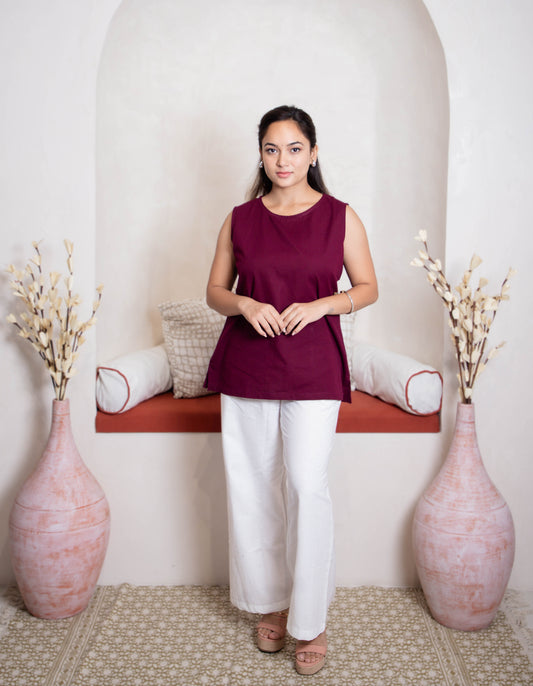 girl wearing maroon top and white pants