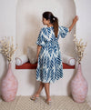 girl in blue branches dress back view
