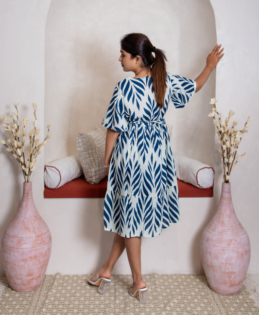 girl in blue branches dress back view