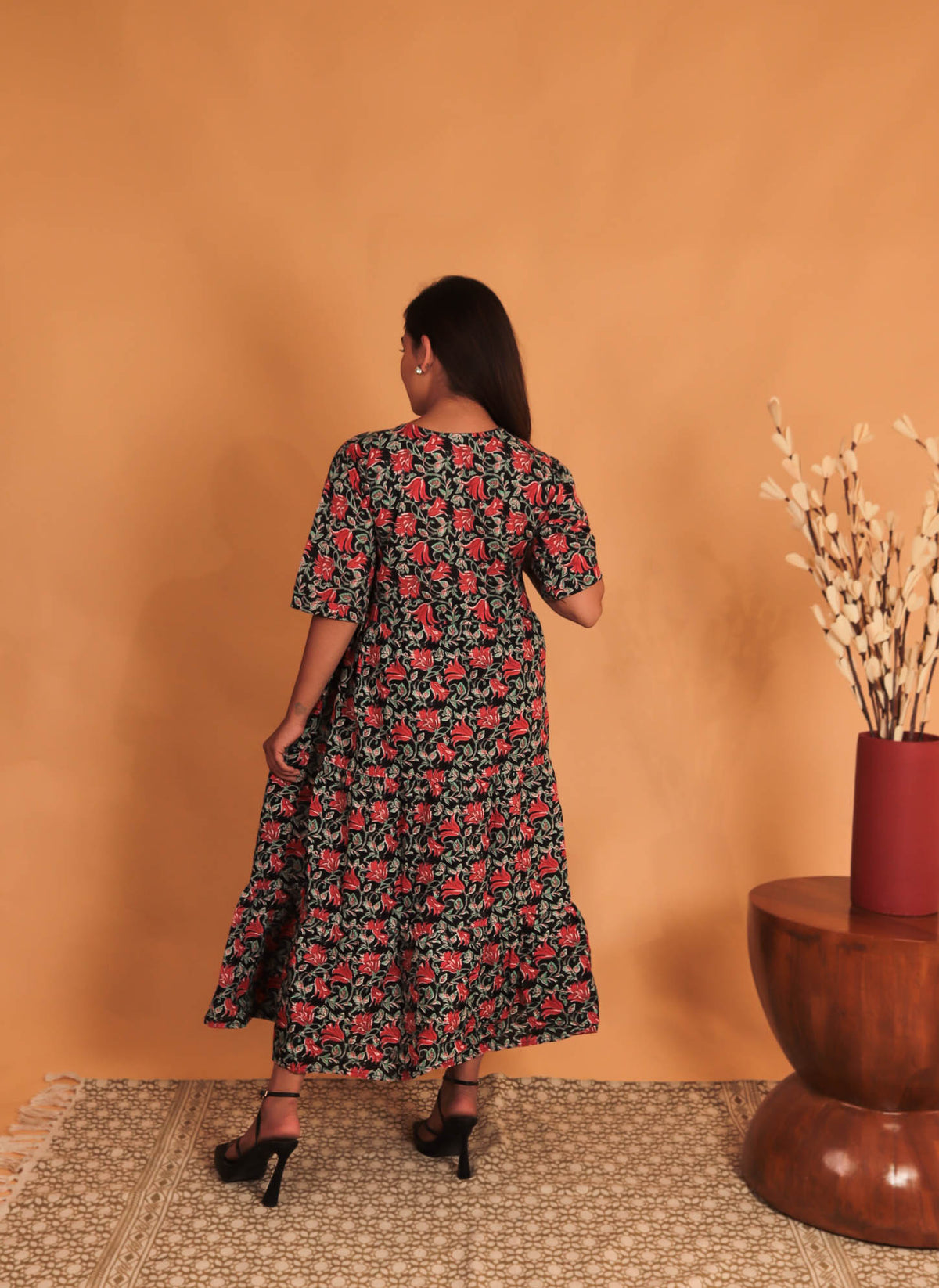 girl in red and grey floral dress