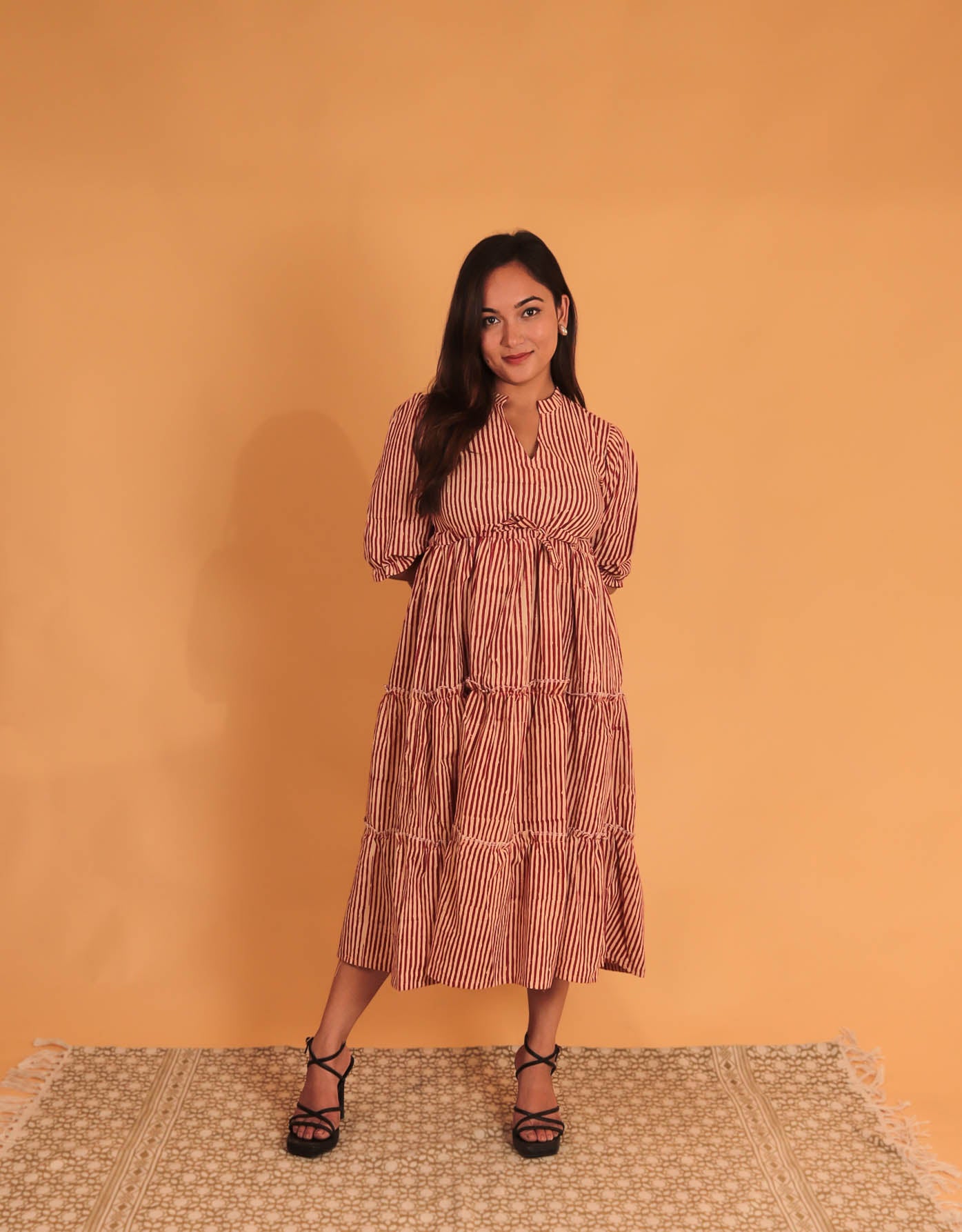 girl in cream stripes dress