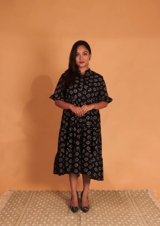girl in a white block printed dress